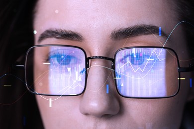 Image of Stock exchange. Trader analyzing data, closeup. Graphs reflecting in her eyeglasses