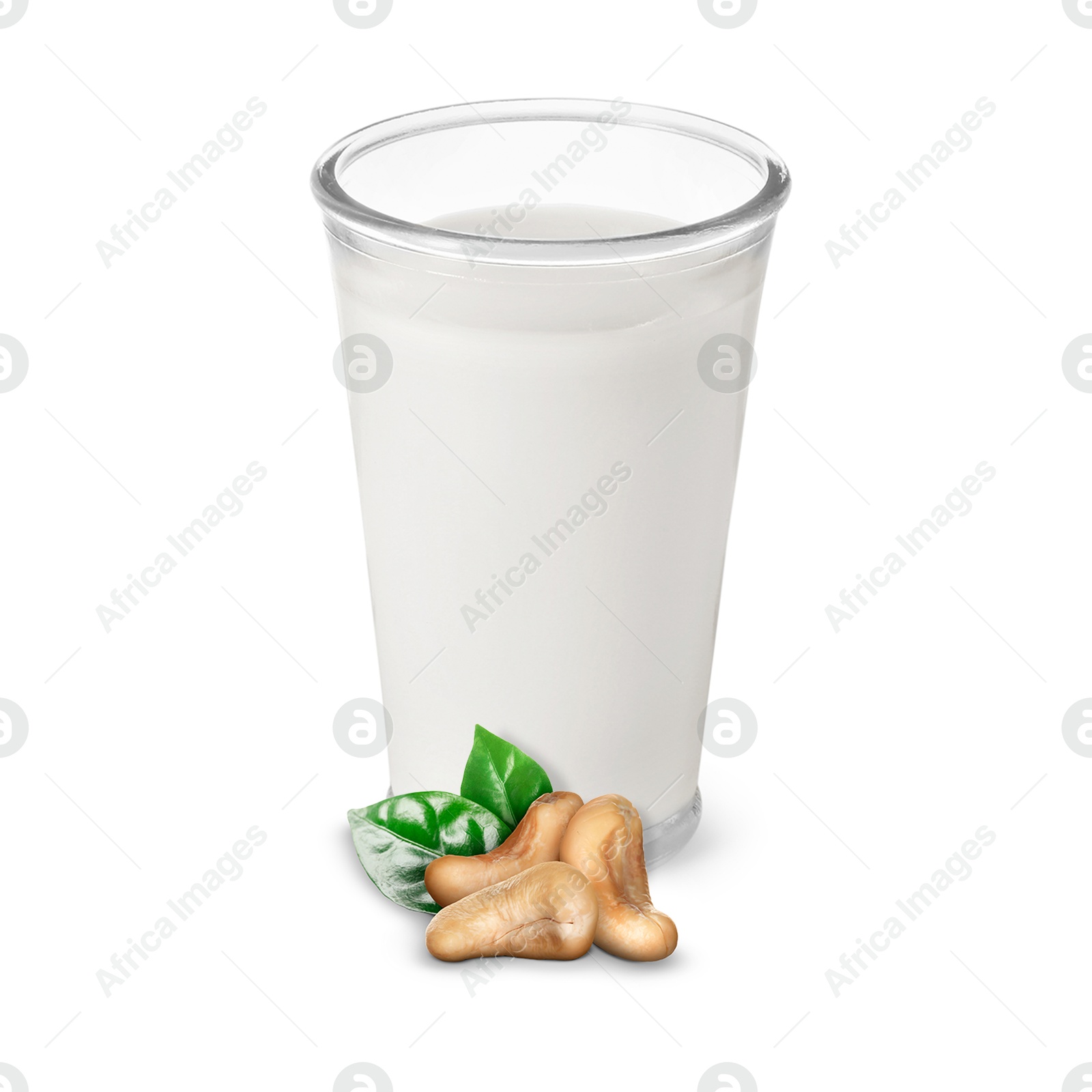 Nut milk in glass and cashews isolated on white Image of Nut milk in glass and cashews isolated on white