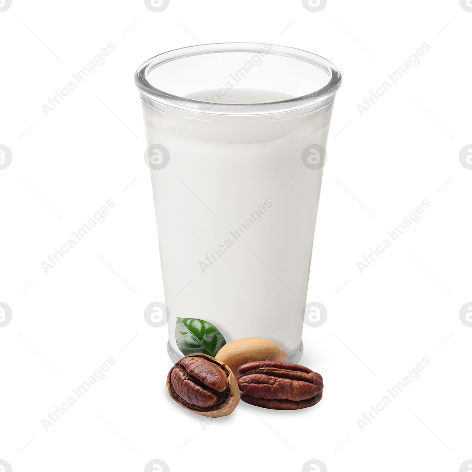 Nut milk in glass and pecans isolated on white Image of Nut milk in glass and pecans isolated on white