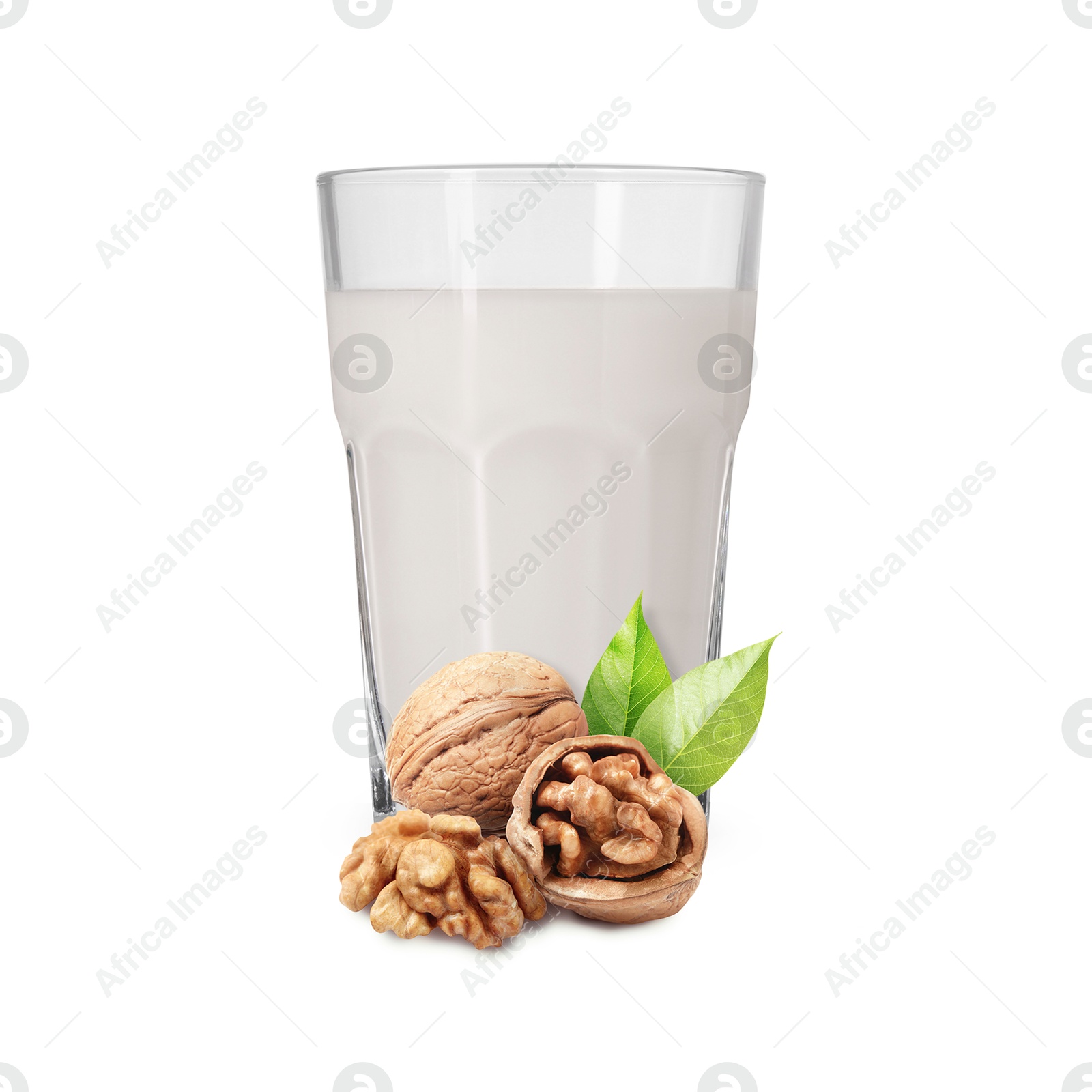 Nut milk in glass and walnuts isolated on white Image of Nut milk in glass and walnuts isolated on white