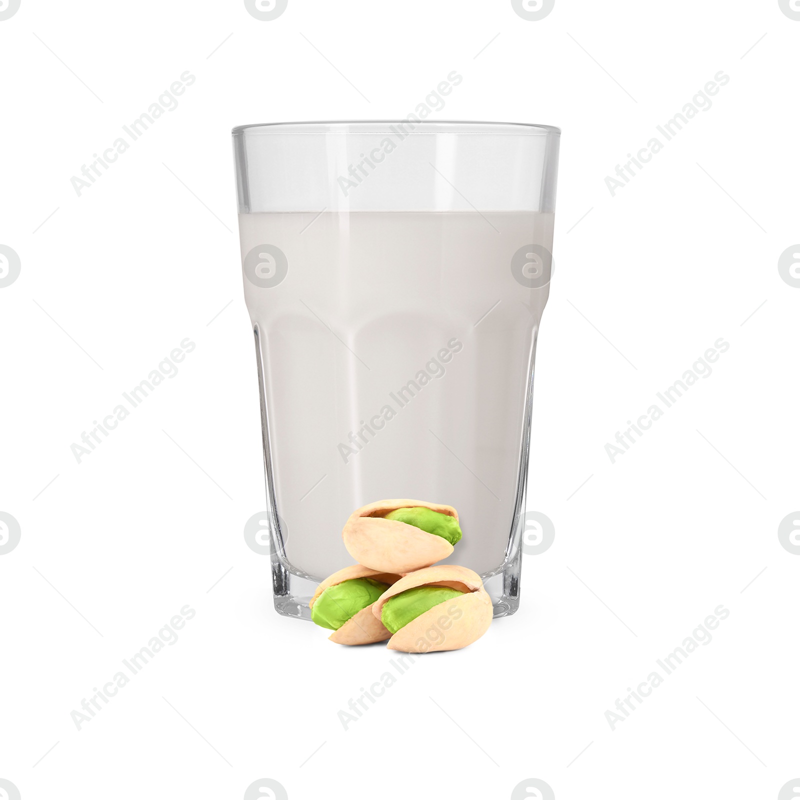 Nut milk in glass and pistachios isolated on white Image of Nut milk in glass and pistachios isolated on white