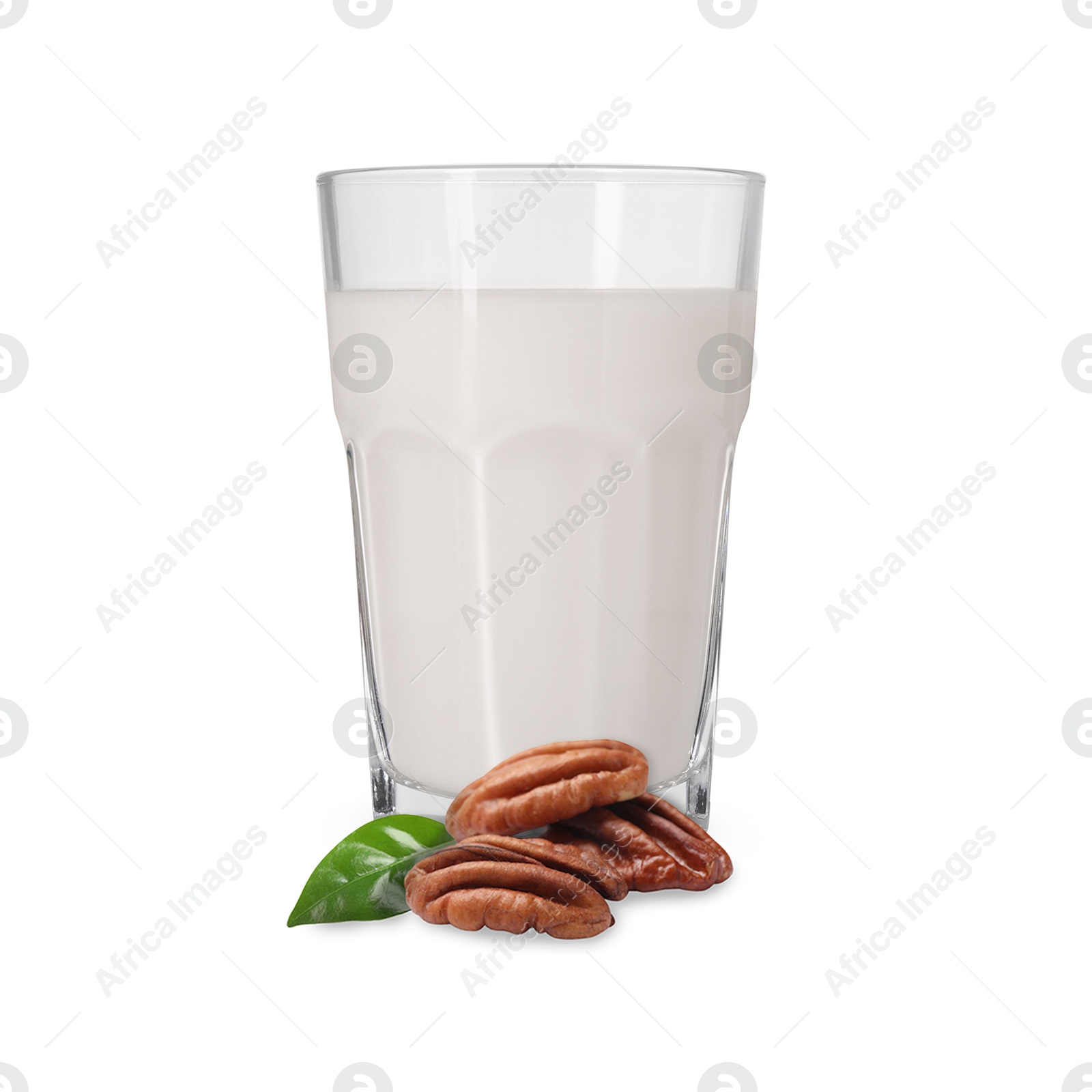 Nut milk in glass and pecans isolated on white Image of Nut milk in glass and pecans isolated on white