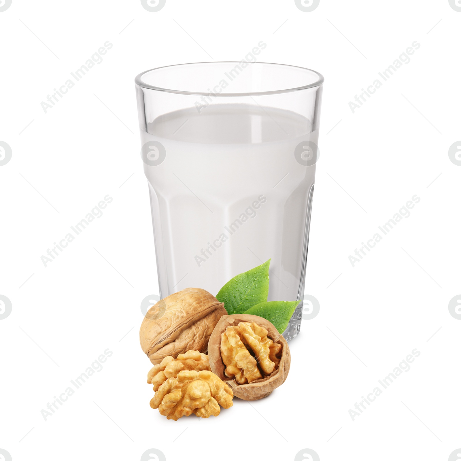 Nut milk in glass and walnuts isolated on white Image of Nut milk in glass and walnuts isolated on white