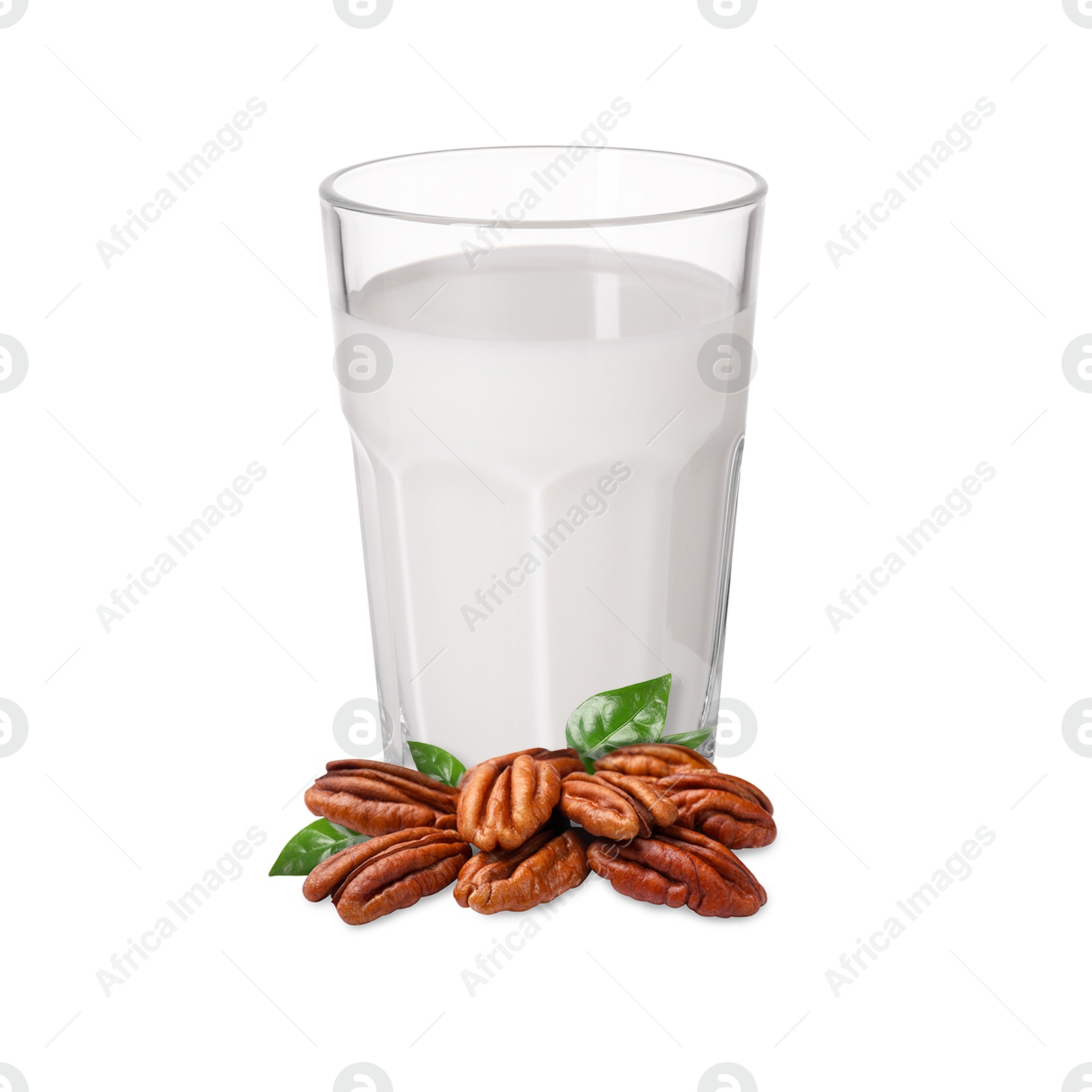Nut milk in glass and pecans isolated on white Image of Nut milk in glass and pecans isolated on white