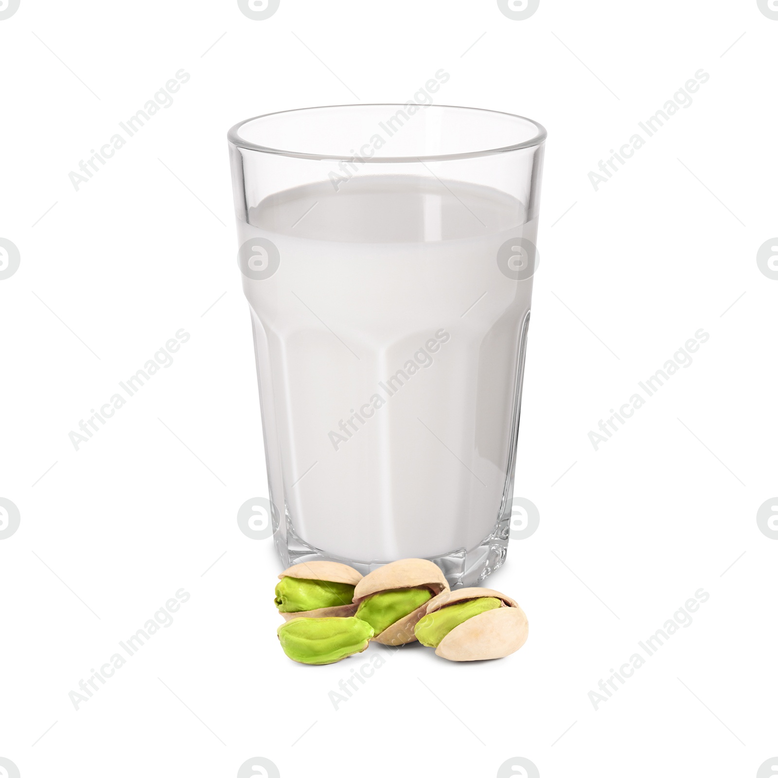 Nut milk in glass and pistachios isolated on white Image of Nut milk in glass and pistachios isolated on white