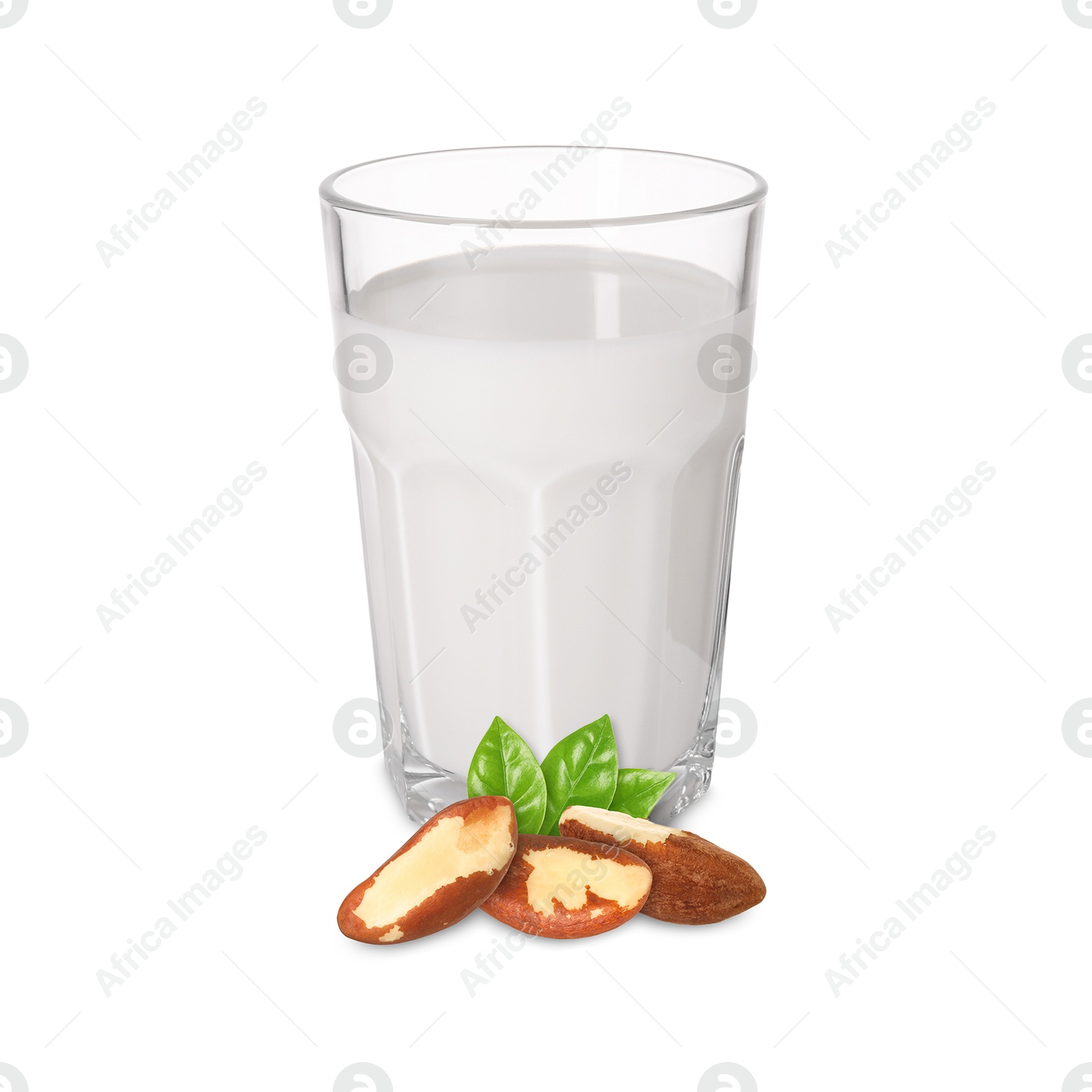 Nut milk in glass and Brazil nuts isolated on white Image of Nut milk in glass and Brazil nuts isolated on white