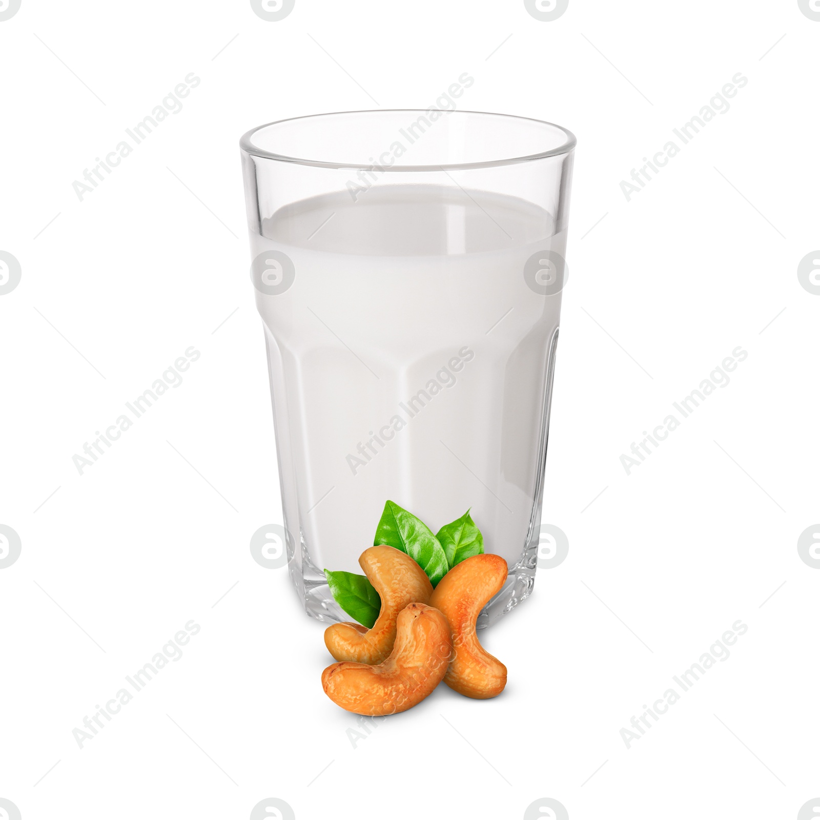 Nut milk in glass and cashews isolated on white Image of Nut milk in glass and cashews isolated on white