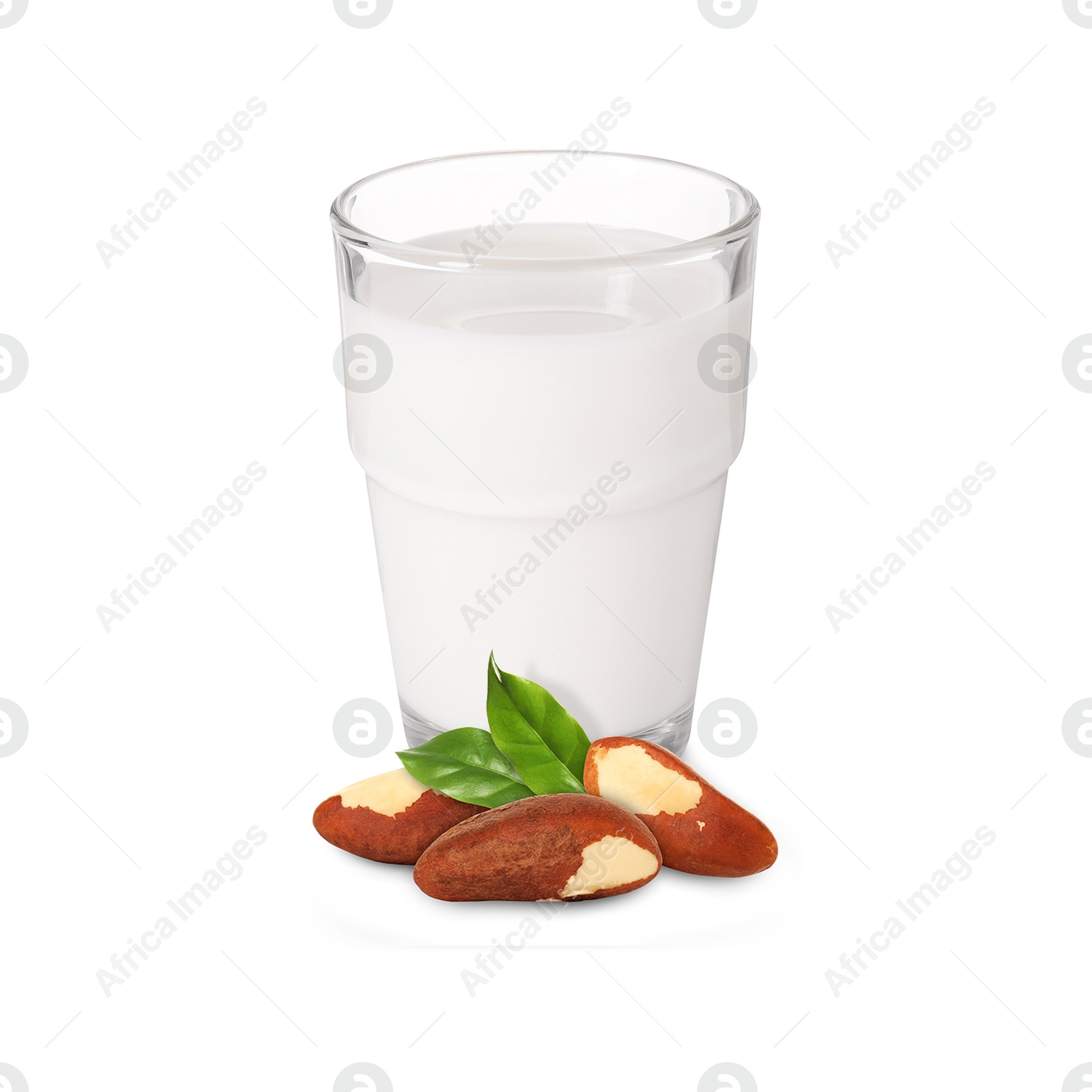 Nut milk in glass and Brazil nuts isolated on white Image of Nut milk in glass and Brazil nuts isolated on white