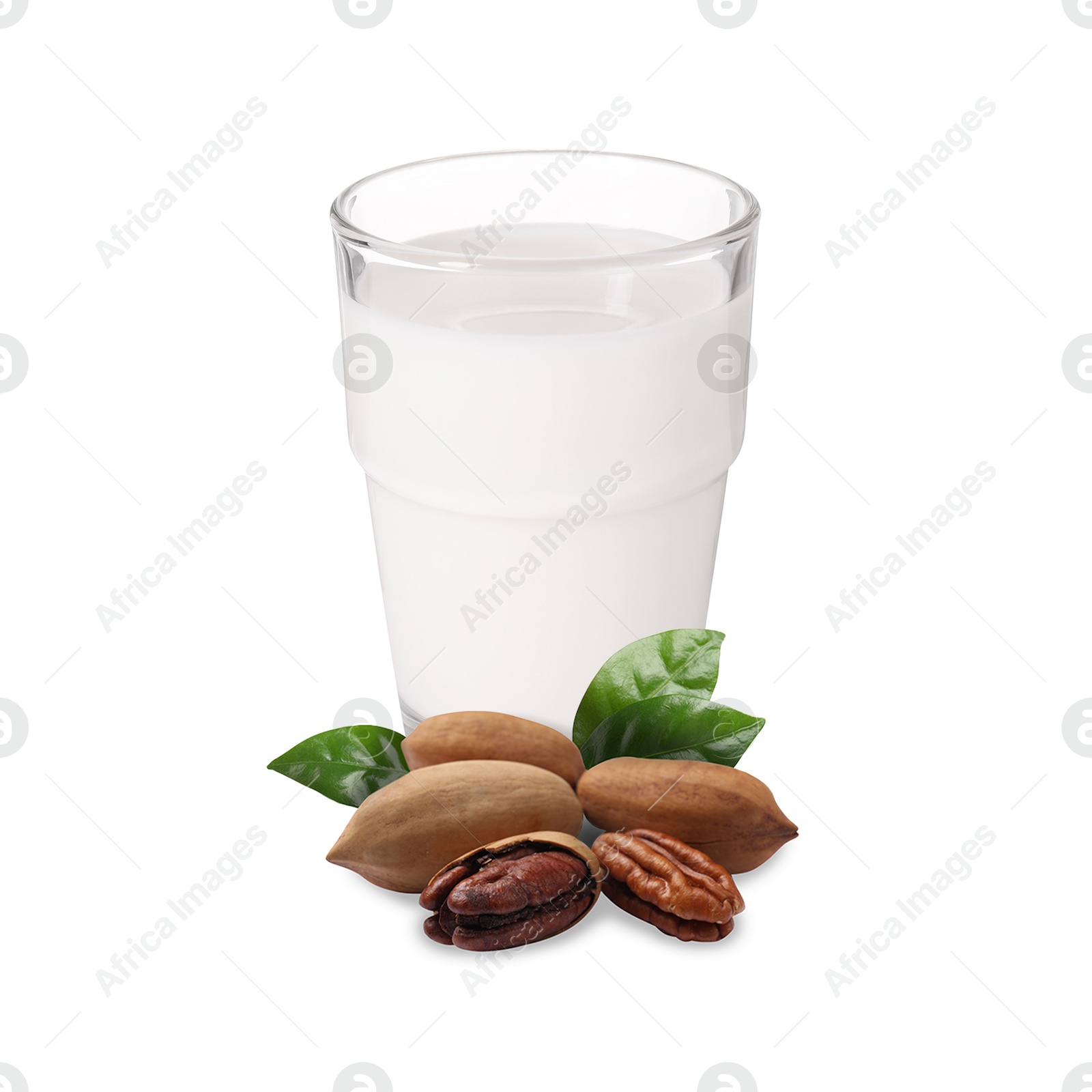 Nut milk in glass and pecans isolated on white Image of Nut milk in glass and pecans isolated on white