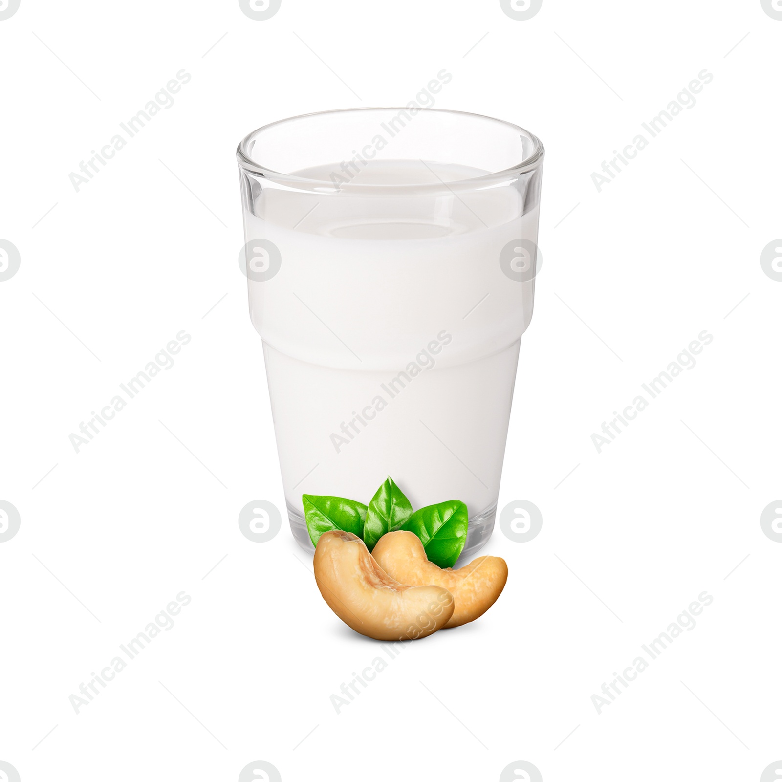 Nut milk in glass and cashews isolated on white Image of Nut milk in glass and cashews isolated on white