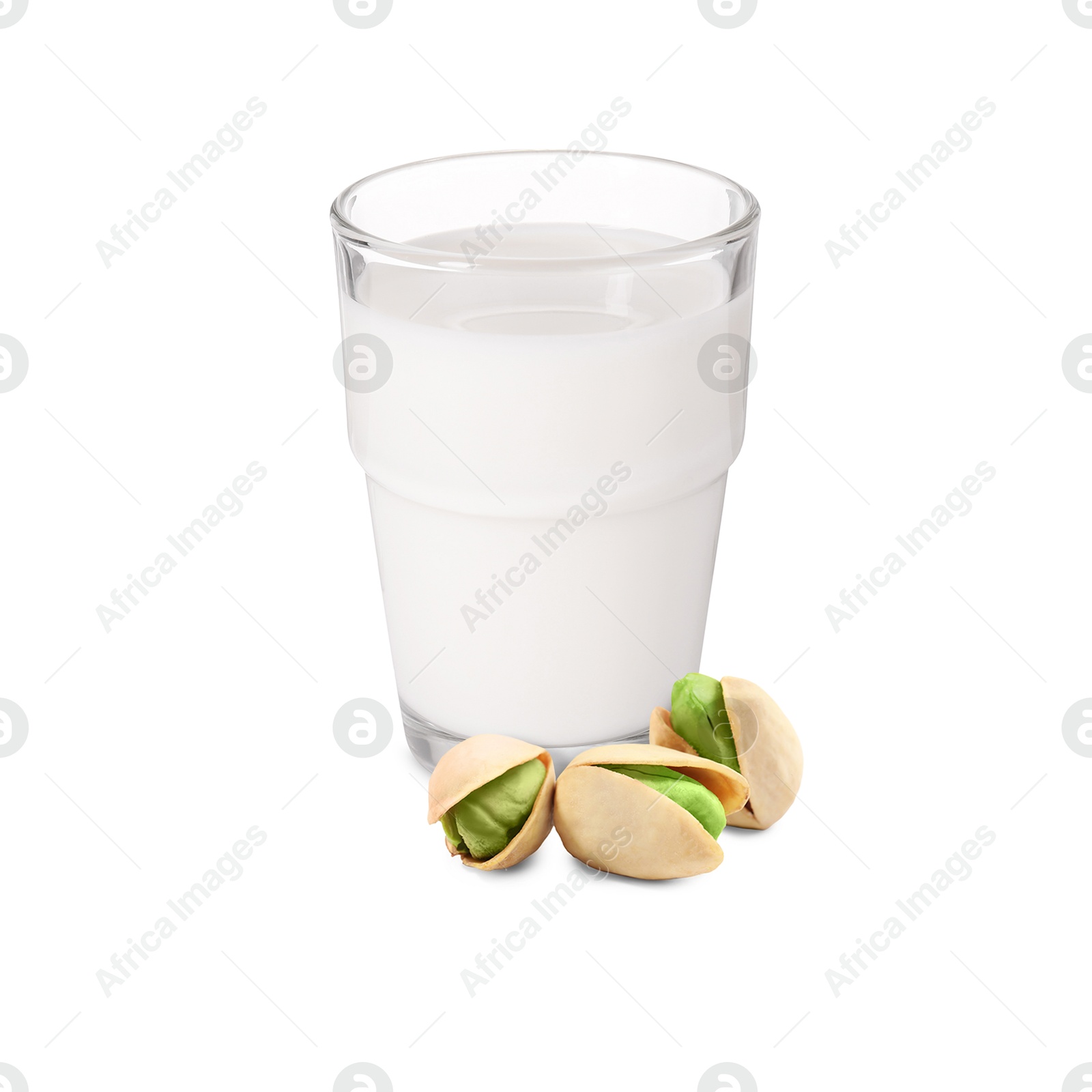 Nut milk in glass and pistachios isolated on white Image of Nut milk in glass and pistachios isolated on white