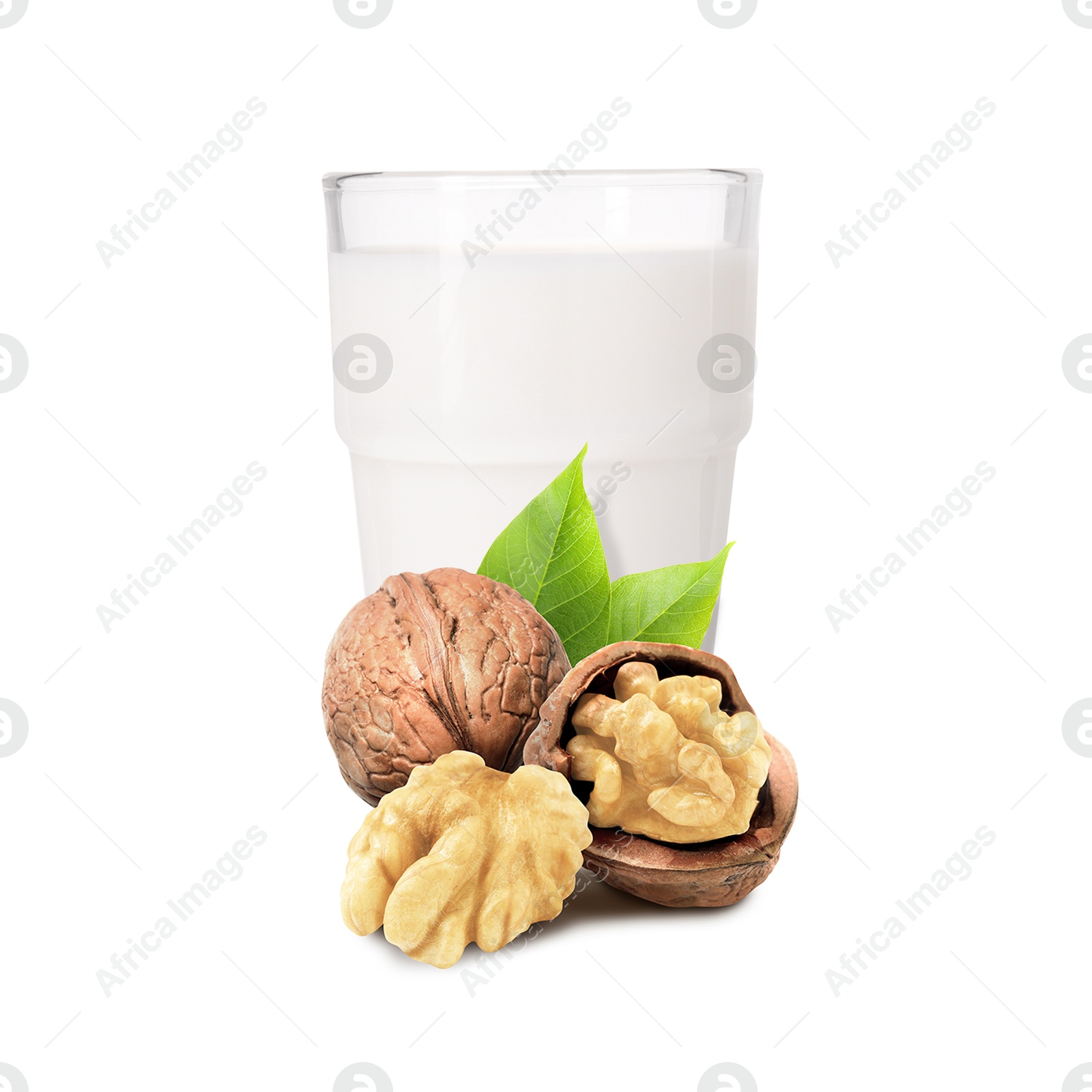 Nut milk in glass and walnuts isolated on white Image of Nut milk in glass and walnuts isolated on white