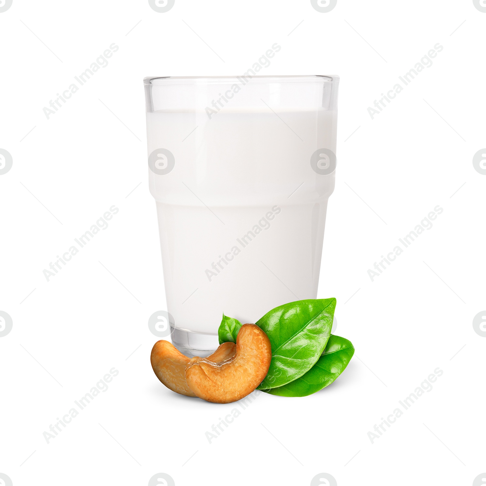 Nut milk in glass and cashews isolated on white Image of Nut milk in glass and cashews isolated on white