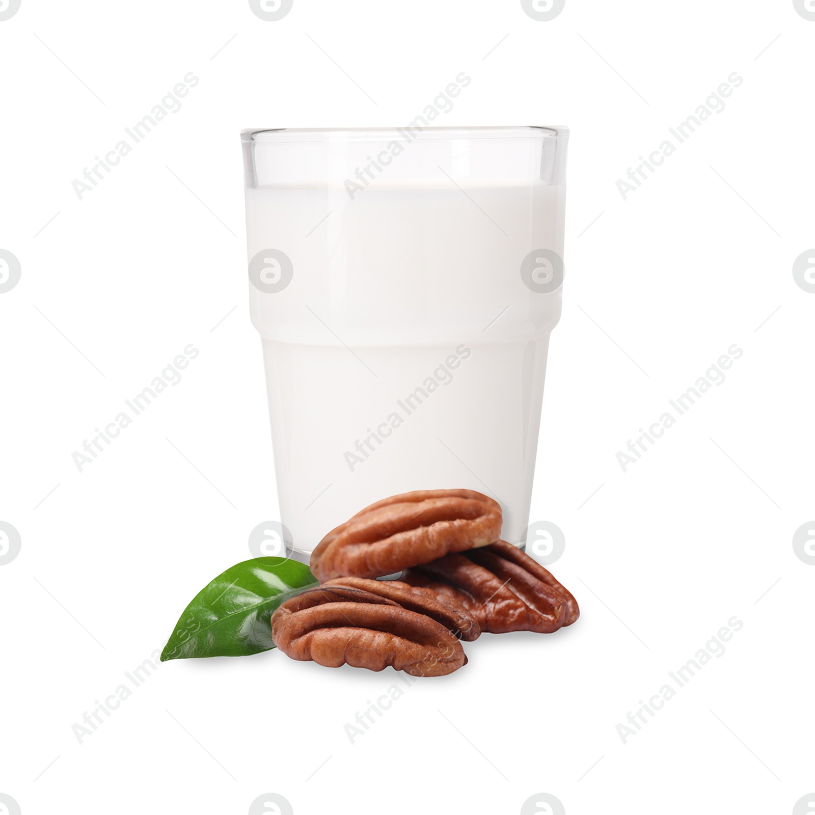 Nut milk in glass and pecans isolated on white Image of Nut milk in glass and pecans isolated on white