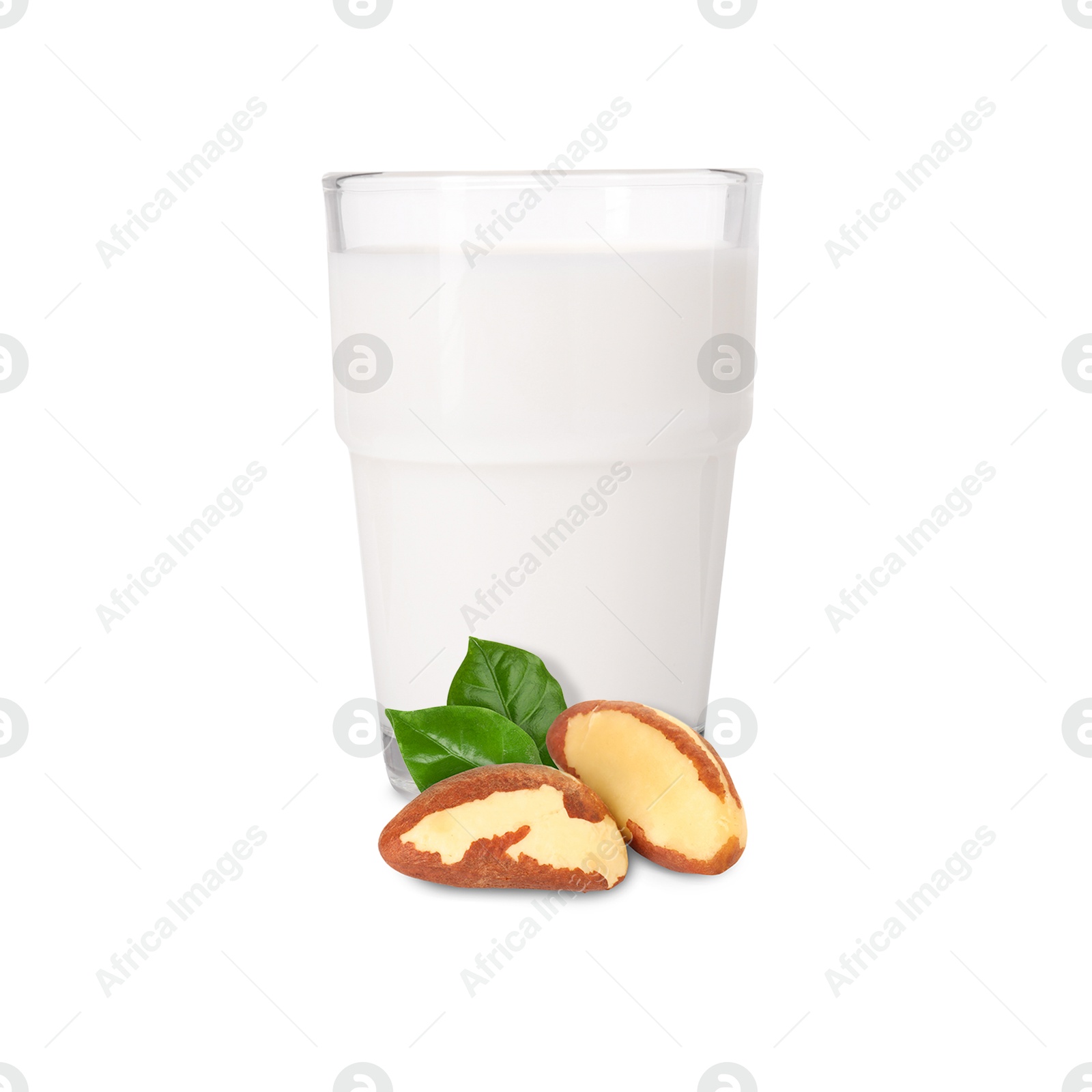 Nut milk in glass and Brazil nuts isolated on white Image of Nut milk in glass and Brazil nuts isolated on white