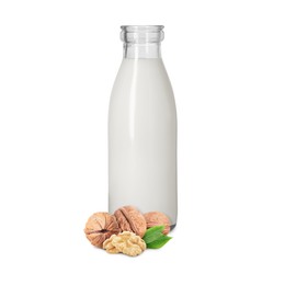 Image of Nut milk in glass bottle and walnuts isolated on white