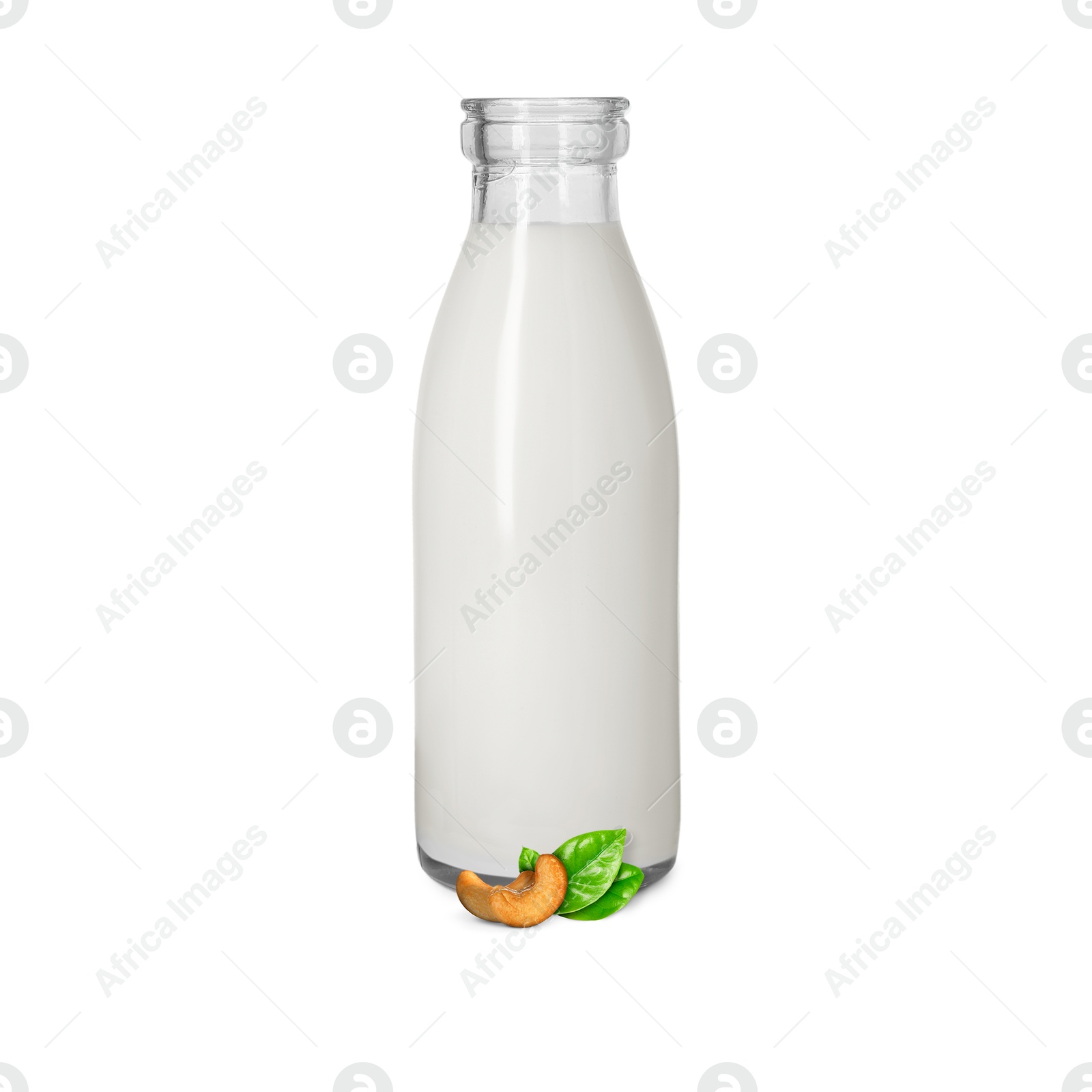 Nut milk in glass bottle and cashews isolated on white Image of Nut milk in glass bottle and cashews isolated on white