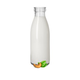 Image of Nut milk in glass bottle and cashews isolated on white