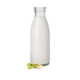 Image of Nut milk in glass bottle and pistachios isolated on white