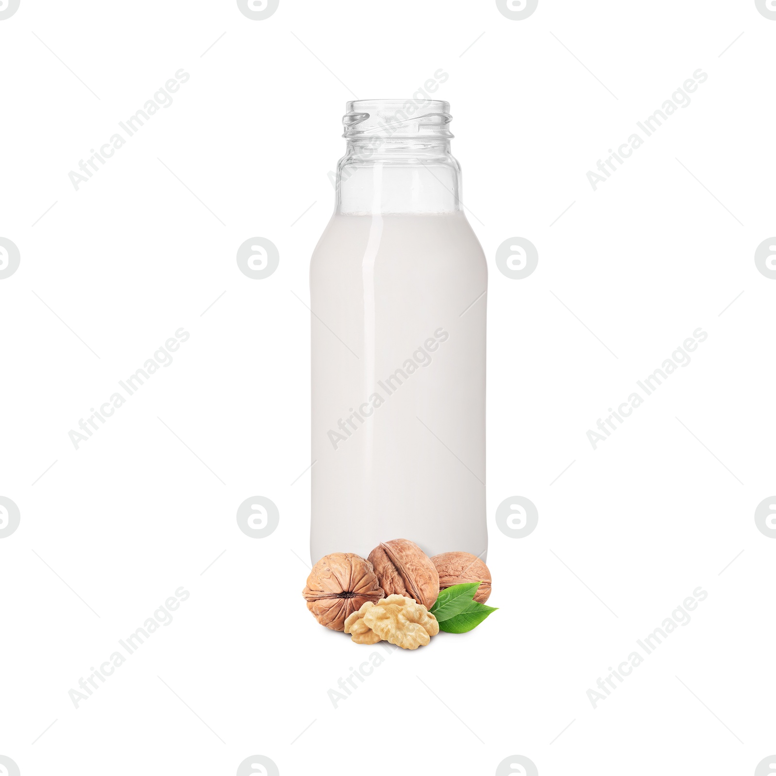 Nut milk in glass bottle and walnuts isolated on white Image of Nut milk in glass bottle and walnuts isolated on white