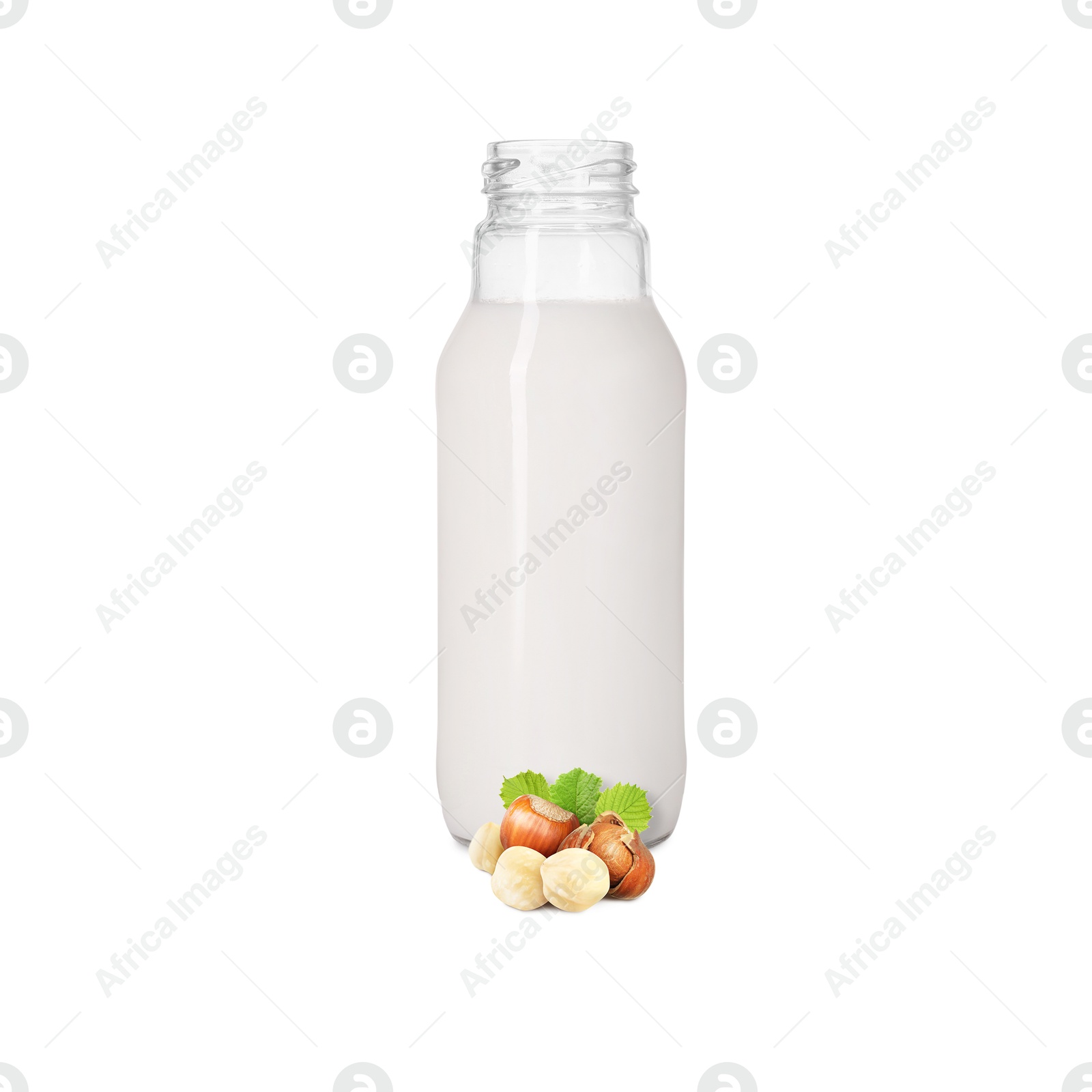Nut milk in glass bottle and hazelnuts isolated on white Image of Nut milk in glass bottle and hazelnuts isolated on white