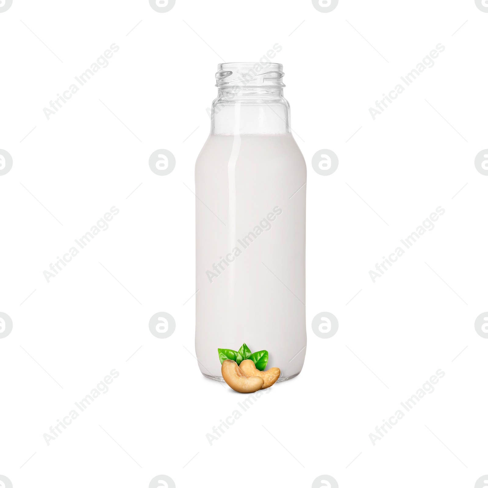 Nut milk in glass bottle and cashews isolated on white Image of Nut milk in glass bottle and cashews isolated on white