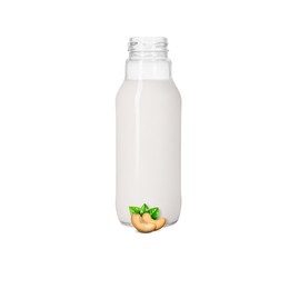 Image of Nut milk in glass bottle and cashews isolated on white