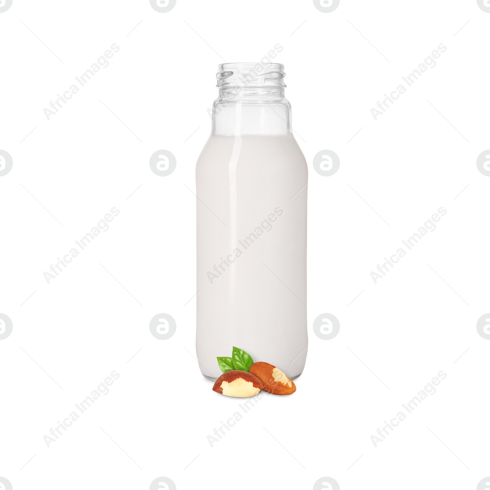 Nut milk in glass bottle and Brazil nuts isolated on white Image of Nut milk in glass bottle and Brazil nuts isolated on white