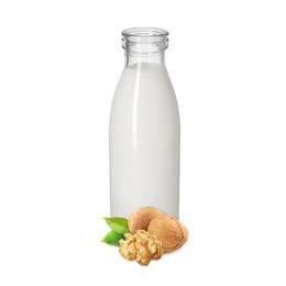 Image of Nut milk in glass bottle and walnuts isolated on white