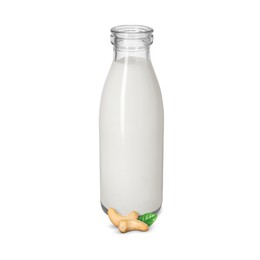 Image of Nut milk in glass bottle and cashews isolated on white