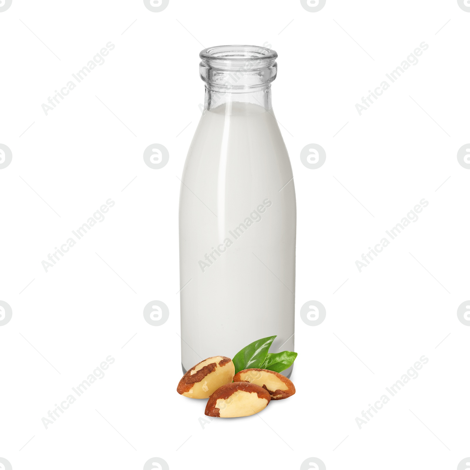 Nut milk in glass bottle and Brazil nuts isolated on white Image of Nut milk in glass bottle and Brazil nuts isolated on white