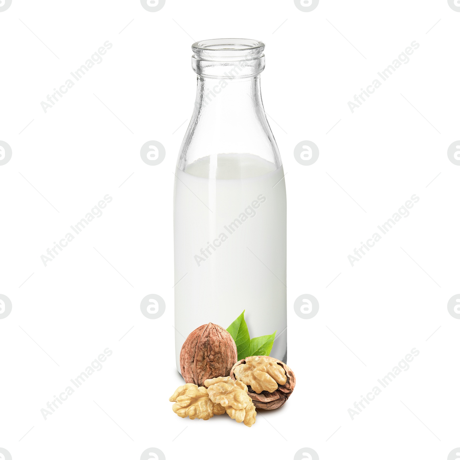 Nut milk in glass bottle and walnuts isolated on white Image of Nut milk in glass bottle and walnuts isolated on white