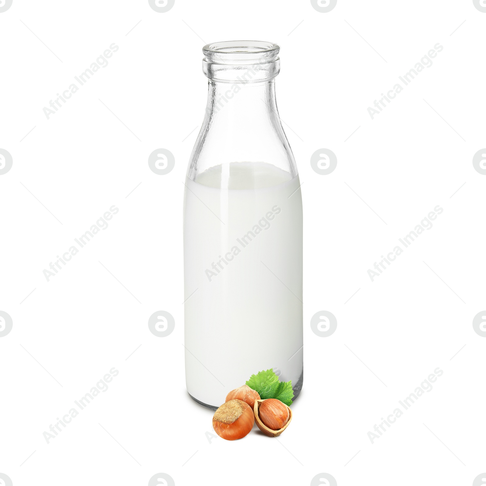 Nut milk in glass bottle and hazelnuts isolated on white Image of Nut milk in glass bottle and hazelnuts isolated on white