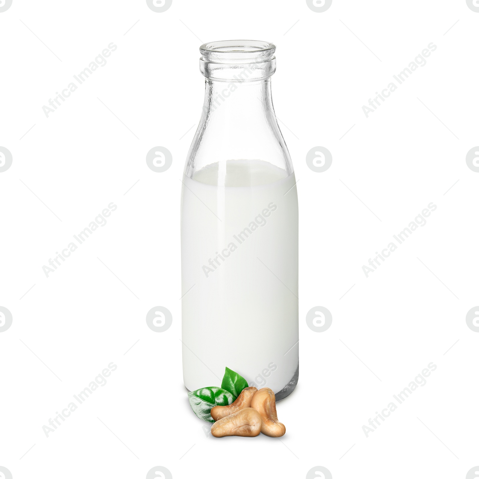 Nut milk in glass bottle and cashews isolated on white Image of Nut milk in glass bottle and cashews isolated on white