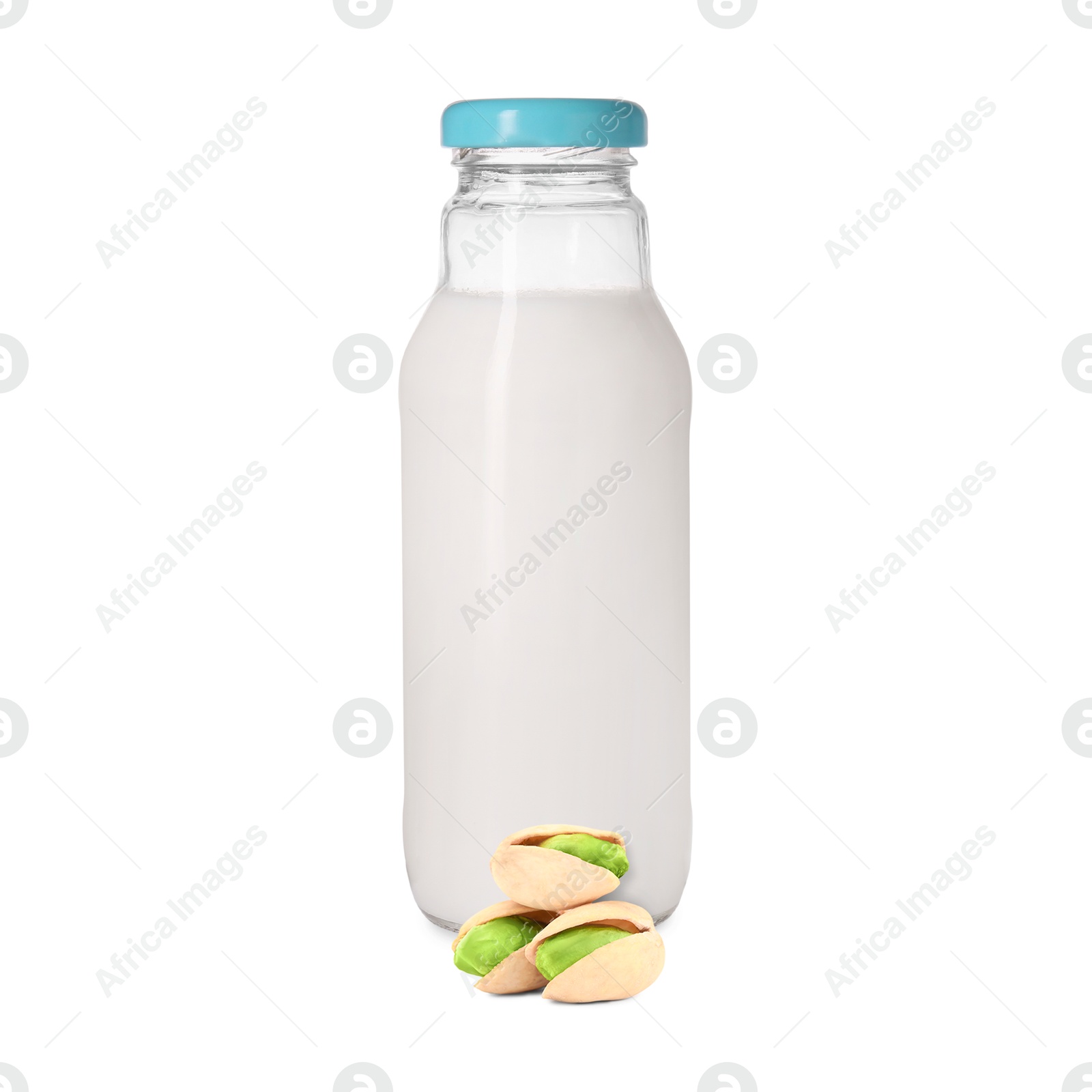 Nut milk in glass bottle and pistachios isolated on white Image of Nut milk in glass bottle and pistachios isolated on white