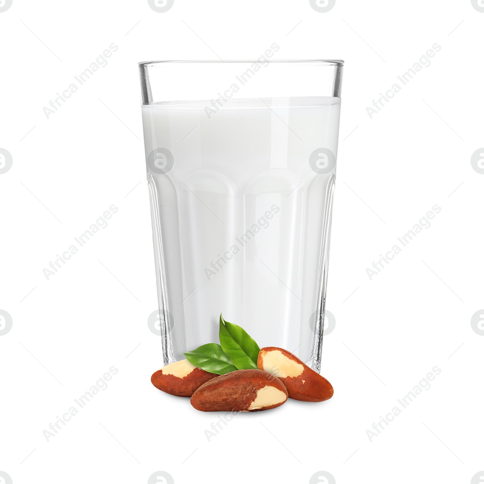 Nut milk in glass and Brazil nuts isolated on white Image of Nut milk in glass and Brazil nuts isolated on white