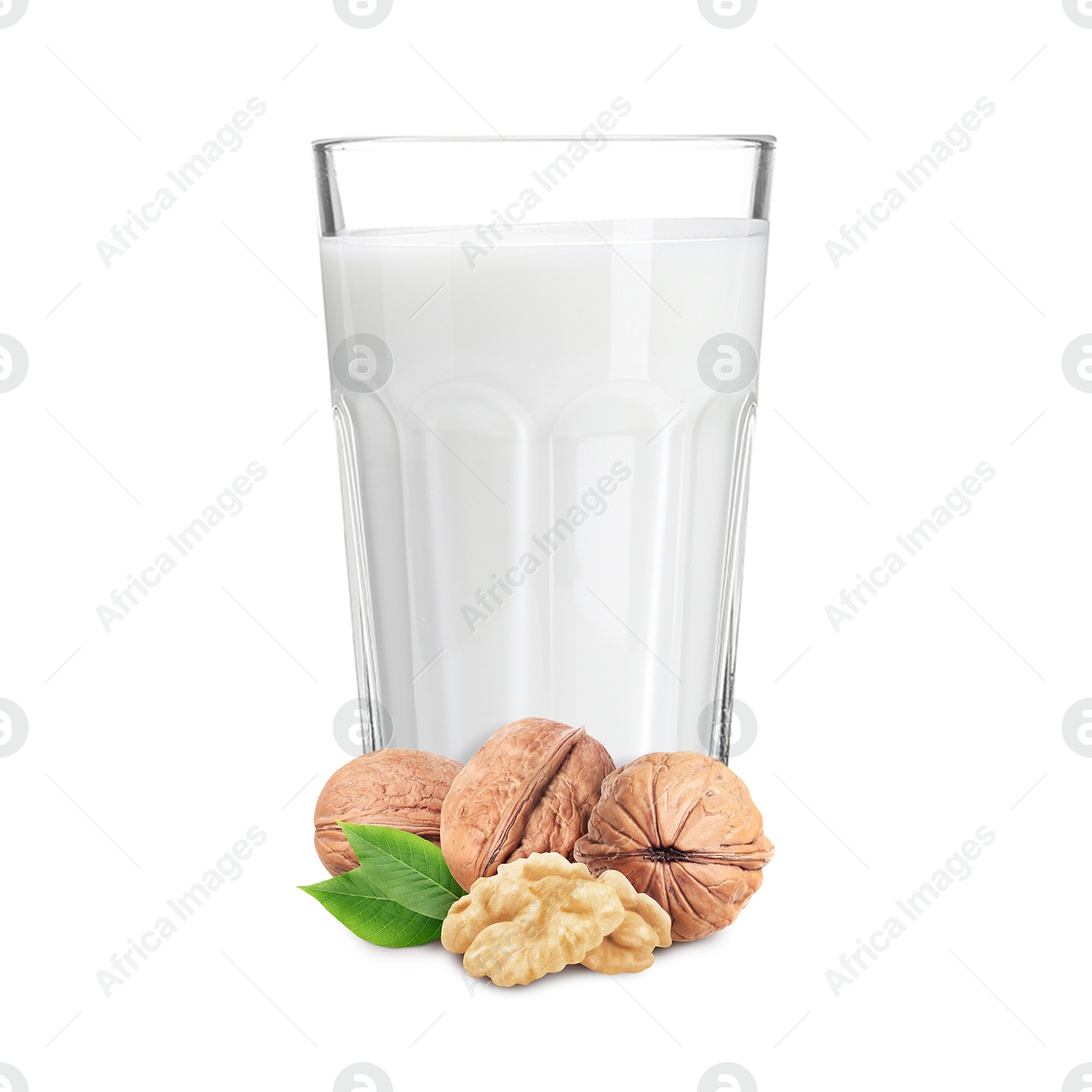 Nut milk in glass and walnuts isolated on white Image of Nut milk in glass and walnuts isolated on white