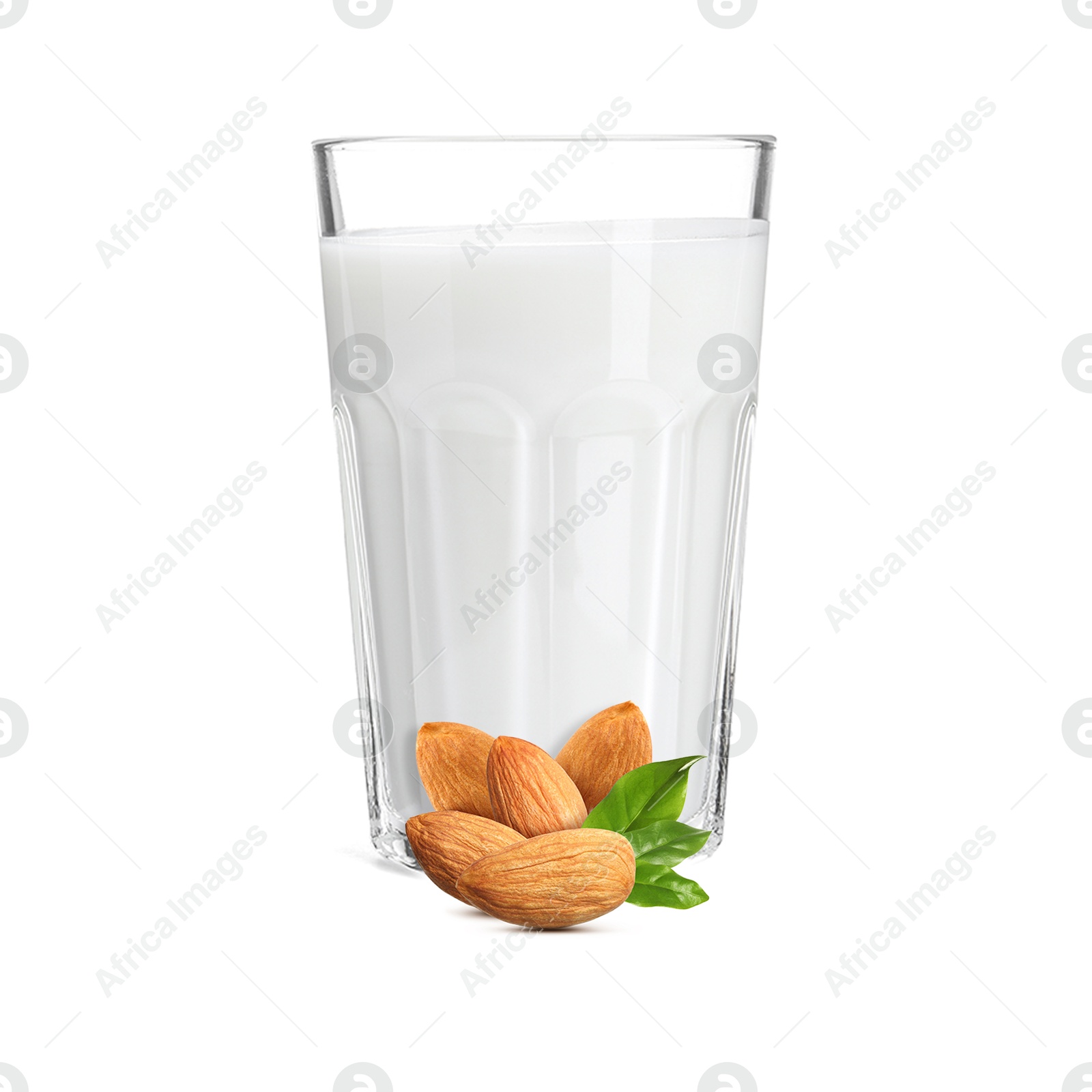 Nut milk in glass and almonds isolated on white Image of Nut milk in glass and almonds isolated on white