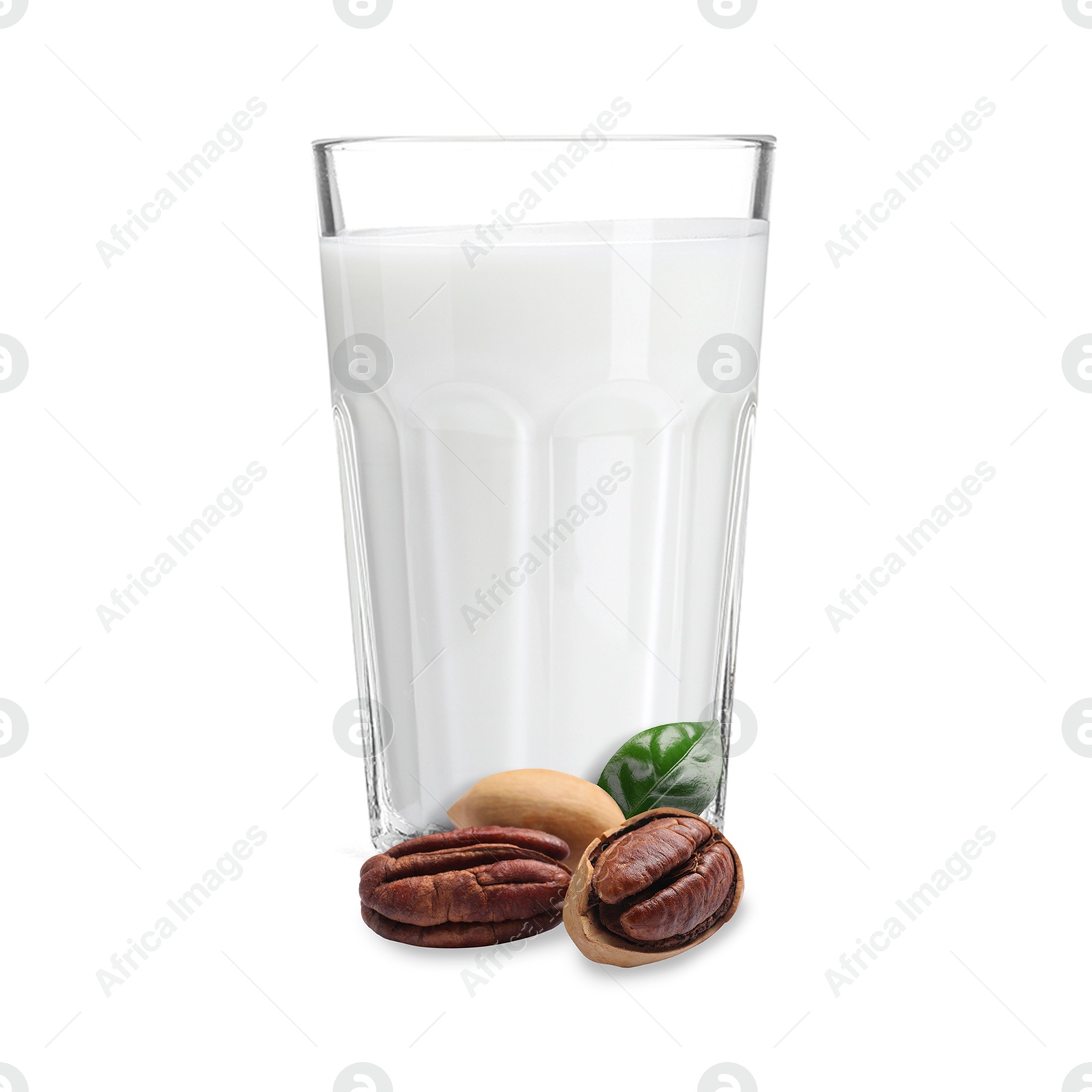 Nut milk in glass and pecans isolated on white Image of Nut milk in glass and pecans isolated on white