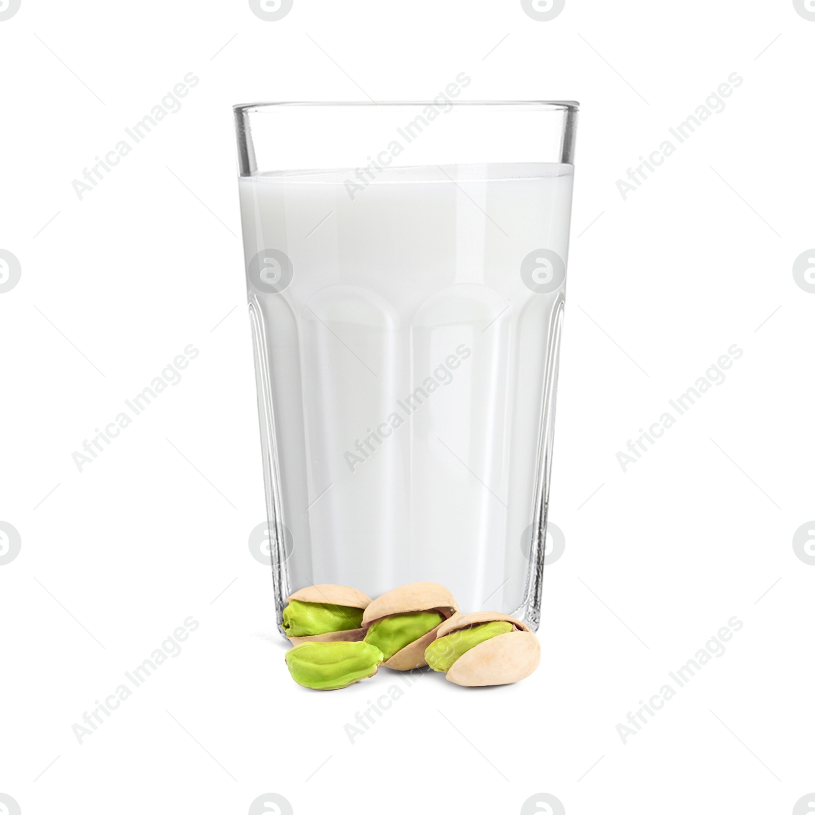 Nut milk in glass and pistachios isolated on white Image of Nut milk in glass and pistachios isolated on white