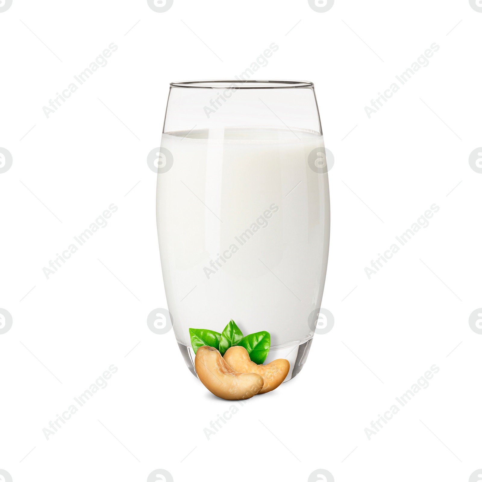Nut milk in glass and cashews isolated on white Image of Nut milk in glass and cashews isolated on white