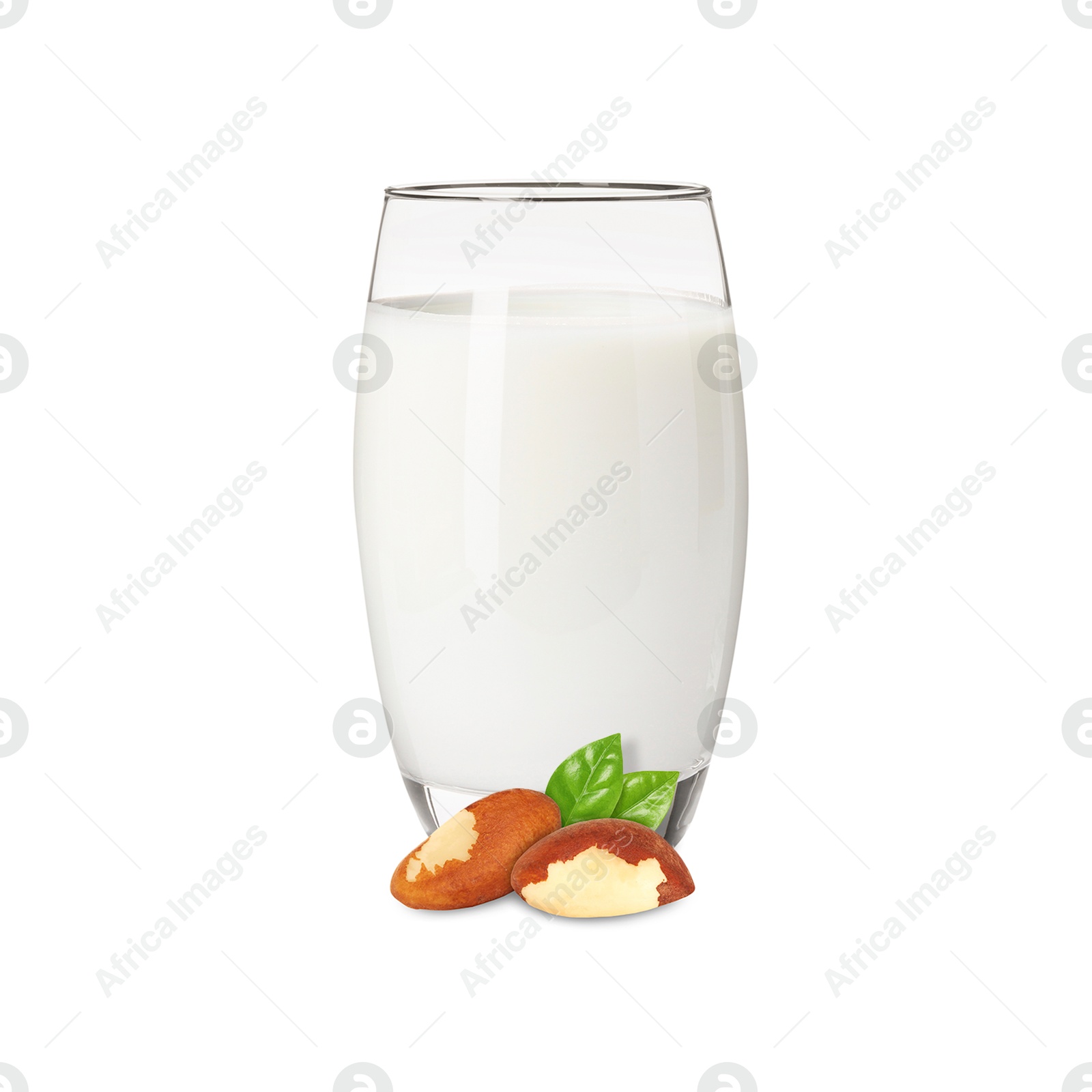 Nut milk in glass and Brazil nuts isolated on white Image of Nut milk in glass and Brazil nuts isolated on white
