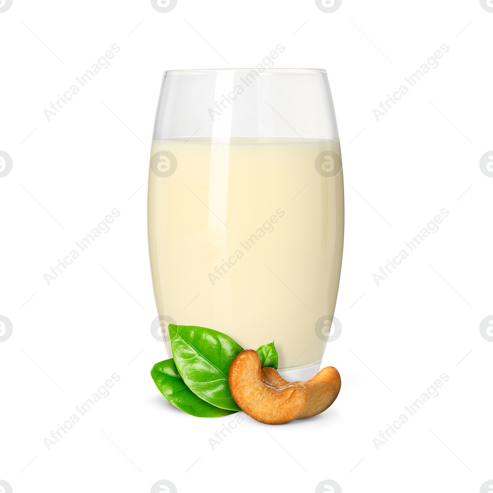 Nut milk in glass and cashews isolated on white Image of Nut milk in glass and cashews isolated on white