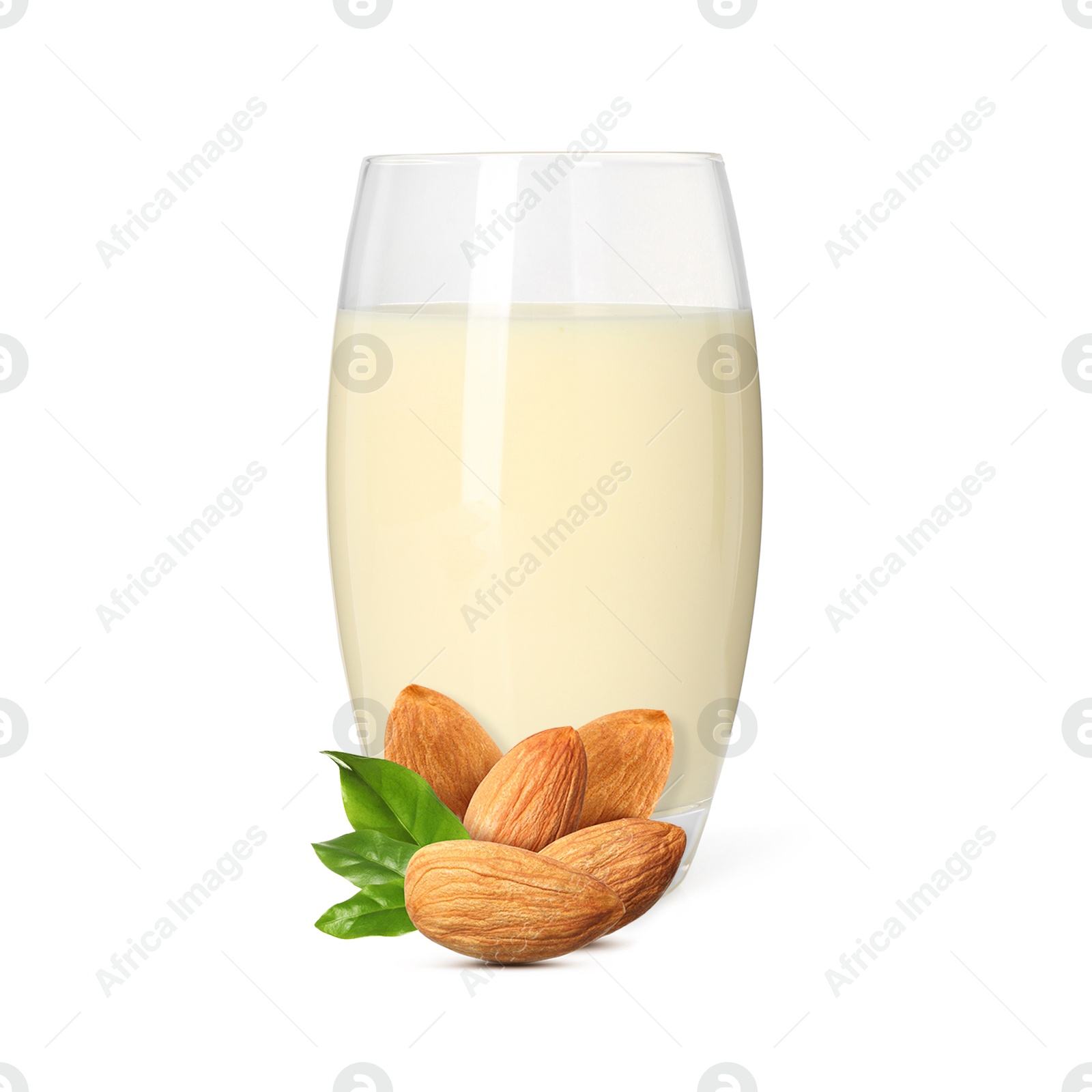Nut milk in glass and almonds isolated on white Image of Nut milk in glass and almonds isolated on white