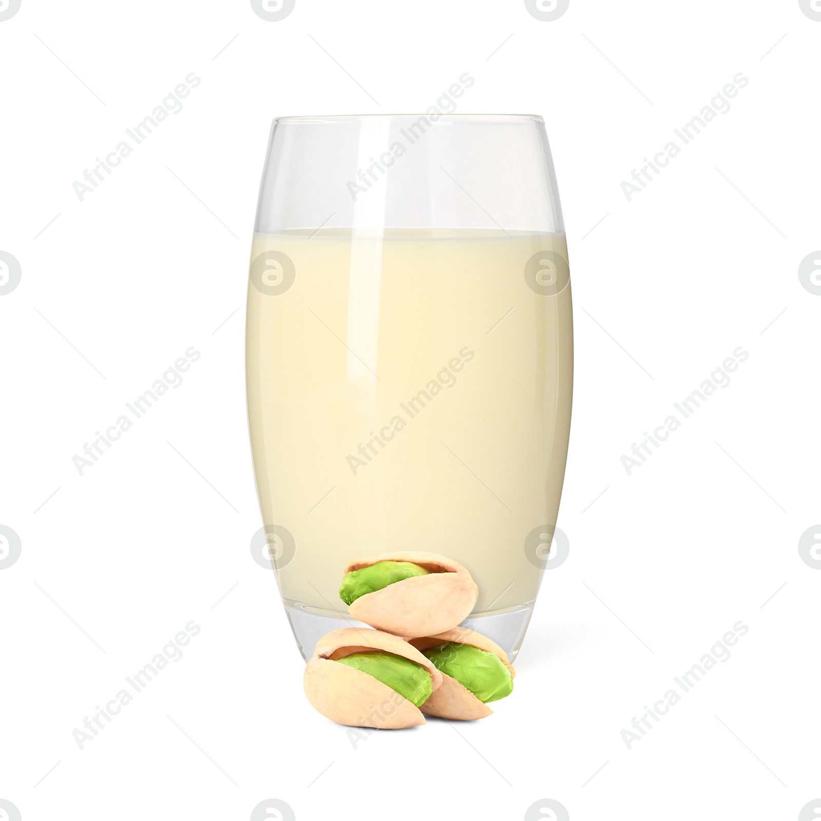 Nut milk in glass and pistachios isolated on white Image of Nut milk in glass and pistachios isolated on white