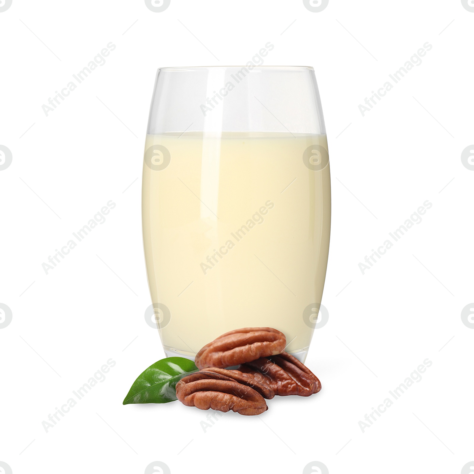 Nut milk in glass and pecans isolated on white Image of Nut milk in glass and pecans isolated on white