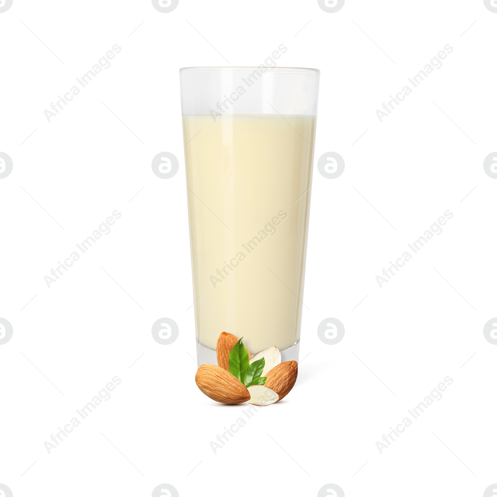 Nut milk in glass and almonds isolated on white Image of Nut milk in glass and almonds isolated on white