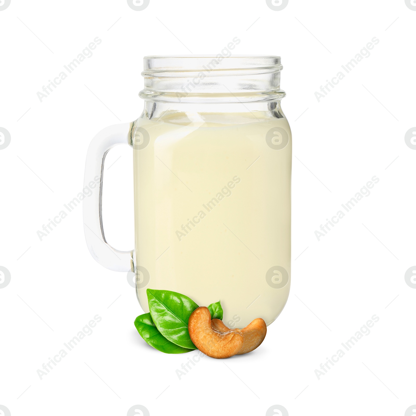 Nut milk in glass jar and cashews isolated on white Image of Nut milk in glass jar and cashews isolated on white