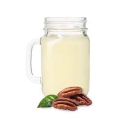 Image of Nut milk in glass jar and pecans isolated on white