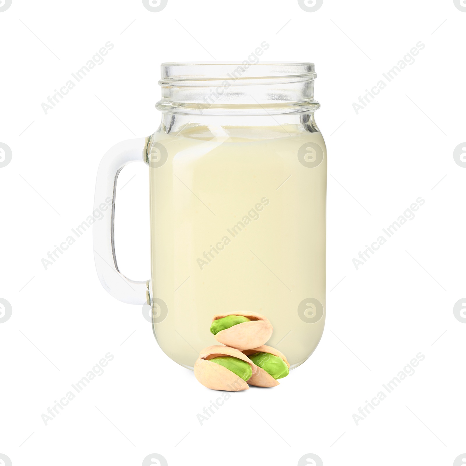 Nut milk in glass jar and pistachios isolated on white Image of Nut milk in glass jar and pistachios isolated on white